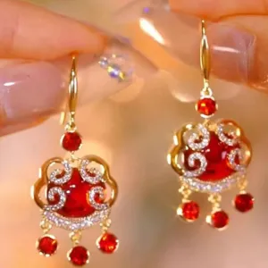 Elegant vintage red Pixiu drop earrings with gold-tone finish and sparkling crystal accents.