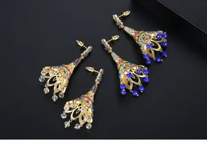 Vue détaillée de boucles d'oreilles dorées de style oriental avec zircons colorés