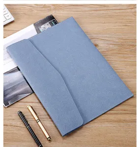 Detailed close-up of blue faux leather A4 business document folder on a professional wooden desk