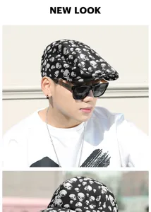 Close-up of stylish black flat cap with white skull print worn by an Asian male model