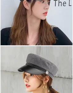 Close-up of a stylish grey baker boy hat with black leather brim and braided cord