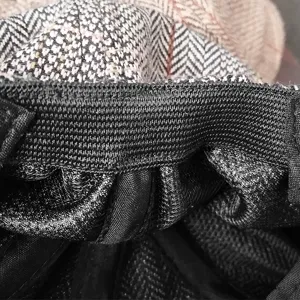 Detailed view of a vintage herringbone newsboy cap featuring a black elastic band