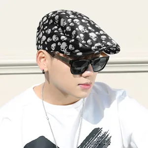 Fashionable black beret flat cap with silver skull print on a male model for casual wear.