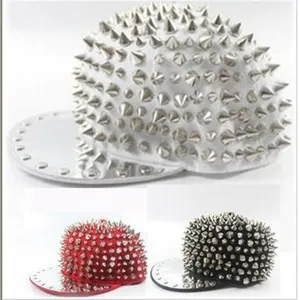 Close-up of punk style hip hop caps with full silver spikes in white red and black