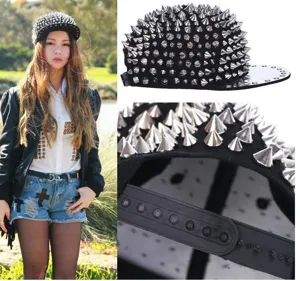 Detail macro shot of silver metal spikes and snapback strap on black punk hip hop hat.