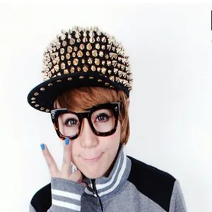 Close-up of a punk hip hop cap with gold-colored metal spikes on an Asian model