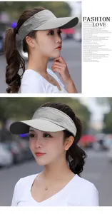 Close-up of a woman wearing a gray mesh breathable sun visor in a street setting