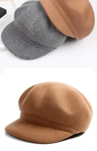Close-up of premium wool texture on camel and grey baker boy hats for autumn and winter