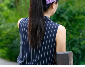 Detailed rear view of a purple camouflage sun visor worn during outdoor sports activities