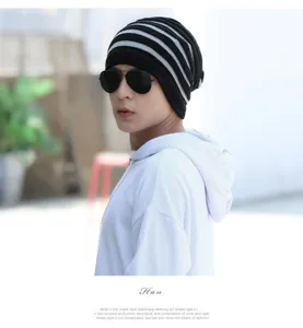 Male model wearing a black and grey striped winter knitted multi-purpose beanie hat.