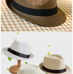 Close-up detail of a breathable straw Fedora hat featuring an elegant black ribbon band