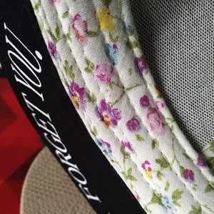 Detailed view of women's floral print baseball cap with FORGET YOU letter embroidery