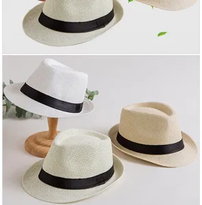 Detailed view of breathable paper straw fedoras with elegant black ribbon bands