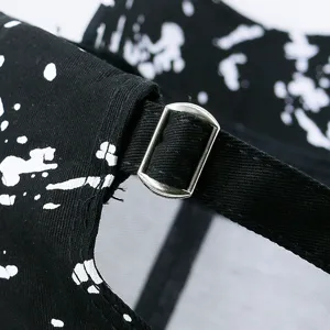 Close-up of black graffiti splash paint baseball cap with adjustable metal buckle
