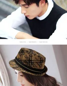 Detailed view of the plaid fedora hat featuring graffiti print and metal zipper decor.
