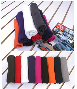 Selection of colorful outdoor fleece neck gaiters rolled on a white slatted display background.
