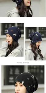 Detailed close-up of a women's navy blue slouchy beanie with cute cartoon cat prints.
