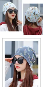 Detail view of women's slouchy beanie featuring colorful feather patterns in blue and grey.