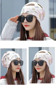 Detailed view of stylish pink turban hat with feather print worn by an Asian model