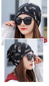Detailed view of women's black slouchy beanie featuring a stylish feather print pattern
