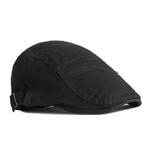 Classic black cotton beret flat cap for men and women featuring retro side buckle detail