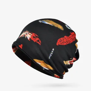 Close-up detail of a soft black turban hat with vibrant colorful feather print patterns