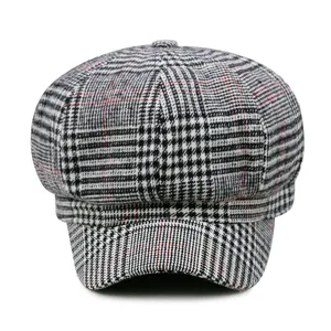 Vintage British style newsboy cap featuring a classic black and white plaid pattern design