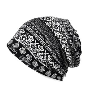Black and white paisley pattern slouchy beanie hat and neck gaiter for outdoor wear.