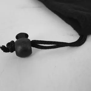 Detailed macro view of the black adjustable drawstring toggle on a warm fleece neck gaiter.