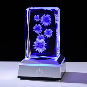 Detail of 3D laser-engraved daisy crystal block glowing with blue light on a base