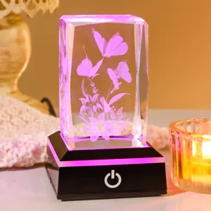 Close-up of 3D laser-etched crystal night light with glowing butterfly pattern