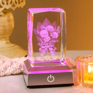 Macro view of 3D laser engraved carnation bouquet inside a glowing crystal cube night light