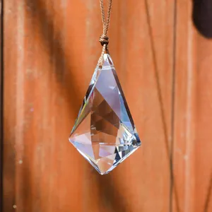 Detailed close-up of a clear K9 faceted crystal prism suncatcher pendant for window hanging
