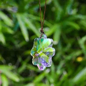 Vista macro detallada de un colgante de cristal iridiscente con forma de flor atrapasol