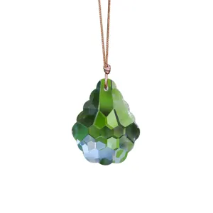 Close-up of green faceted K9 crystal sun catcher prism pendant for window