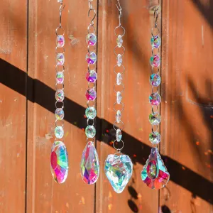 Close-up of four crystal suncatchers creating rainbow light on a wooden fence.