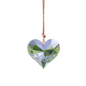 Close-up of faceted K9 heart crystal suncatcher pendant reflecting light