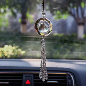 Crystal car hanging ornament detail, sparkling faceted glass ball pendant for rearview mirror decor.