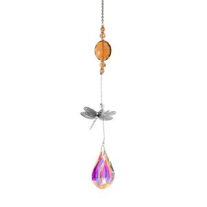 Detailed view of dragonfly crystal suncatcher featuring a large iridescent teardrop prism