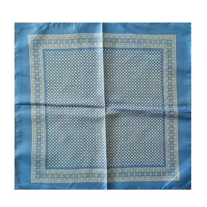 Bandana azul con lunares blancos y detalle de borde geométrico floral.