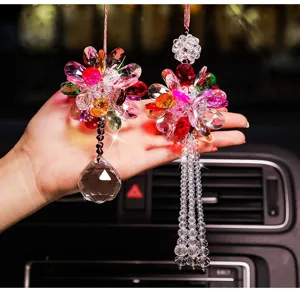 Close-up of colorful crystal car hangings with crystal ball and tassel details