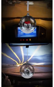 Detailed close-up of a crystal ball car hanging ornament with snowflake and red heart