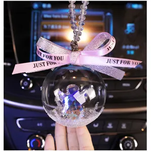 Detailed view of crystal car hanging ornament with angel and pink ribbon