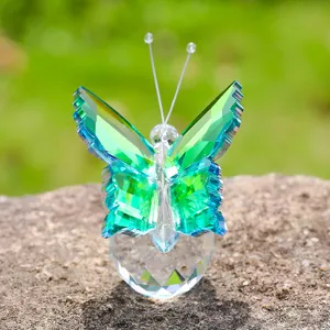 Macro view of a faceted green crystal butterfly figurine resting on a clear base ornament