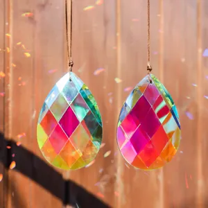 Macro view of teardrop faceted crystal sun catchers with iridescent rainbow reflections