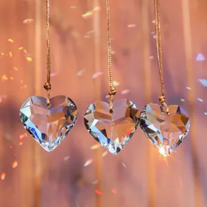 Detail view of heart-shaped K9 crystal faceted prism suncatchers with rainbow reflections