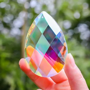 Macro view of a faceted K9 crystal teardrop suncatcher with iridescent reflections