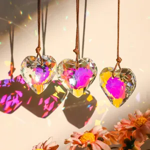 Detailed view of faceted heart crystal suncatcher pendant with colorful rainbow light refraction.
