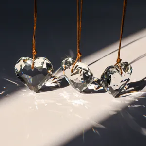 Macro view of faceted K9 crystal heart pendants creating beautiful rainbow light refractions