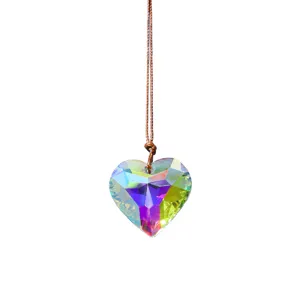 Crystal heart pendant detail, faceted sun catcher prism, hanging window ornament decor.